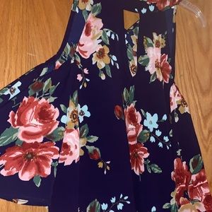 A navy blue cold shoulder top with a rose print!